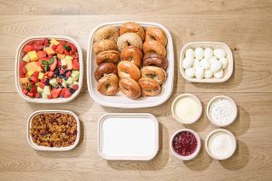 A tempting breakfast and brunch spread, featuring a variety of fresh bagels, creamy spreads, fresh fruits, and crunchy granola for a delicious and satisfying meal.