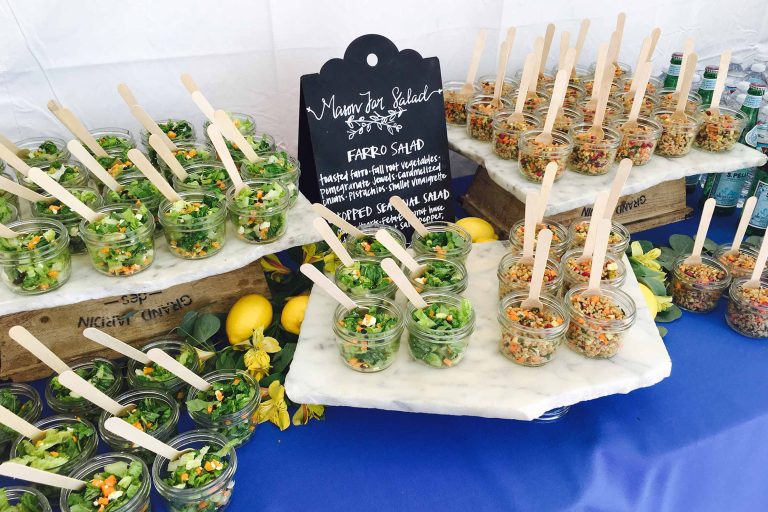 Artfully displayed individual mason jar salads, perfect for your next catered event or gathering.